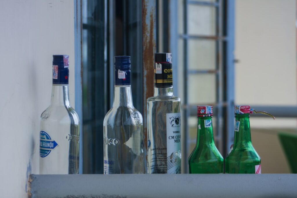a row of bottles on a window sill