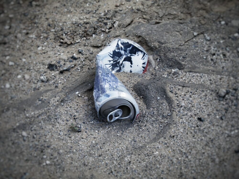 a can of soda on the ground