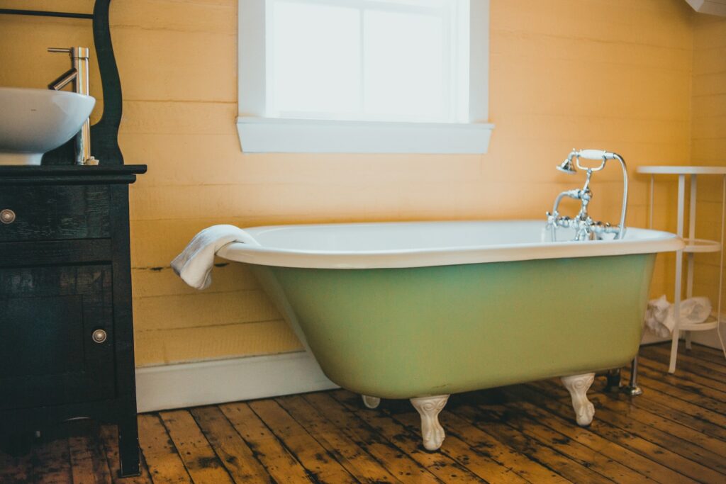 white ceramic bathtub near white wall